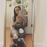 Picture of Brandy Colbert taking a selfie in the mirror while sitting down