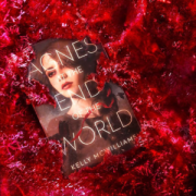 Picture of 'Agnes at the End of the World' sitting in a pile of red tinsel