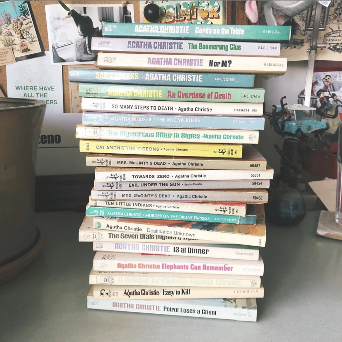 Pile of paperback books on a desk, authored by Agatha Christie